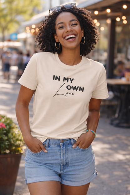 Woman wearing cream graphic t-shirt styled as modern streetwear look