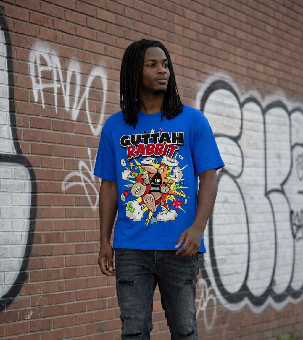 male model wearing blue guttah rabbit graphic streetwear t-shirt in urban setting